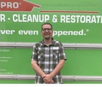 Man in plaid shirt in front of truck