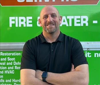 Man in front of green truck